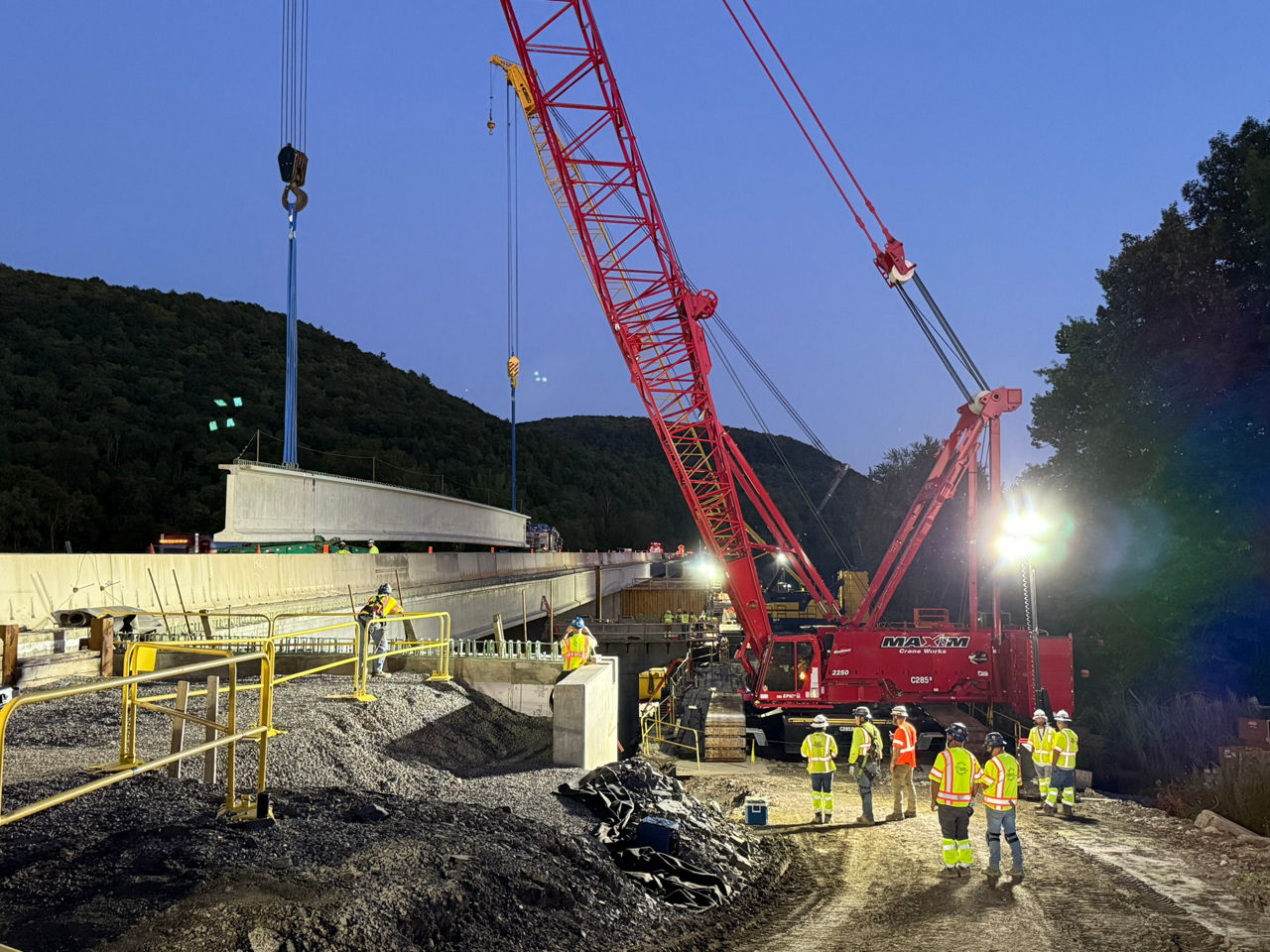 Tandem cranes lift the girders into place at the Susquehanna River Bridge.