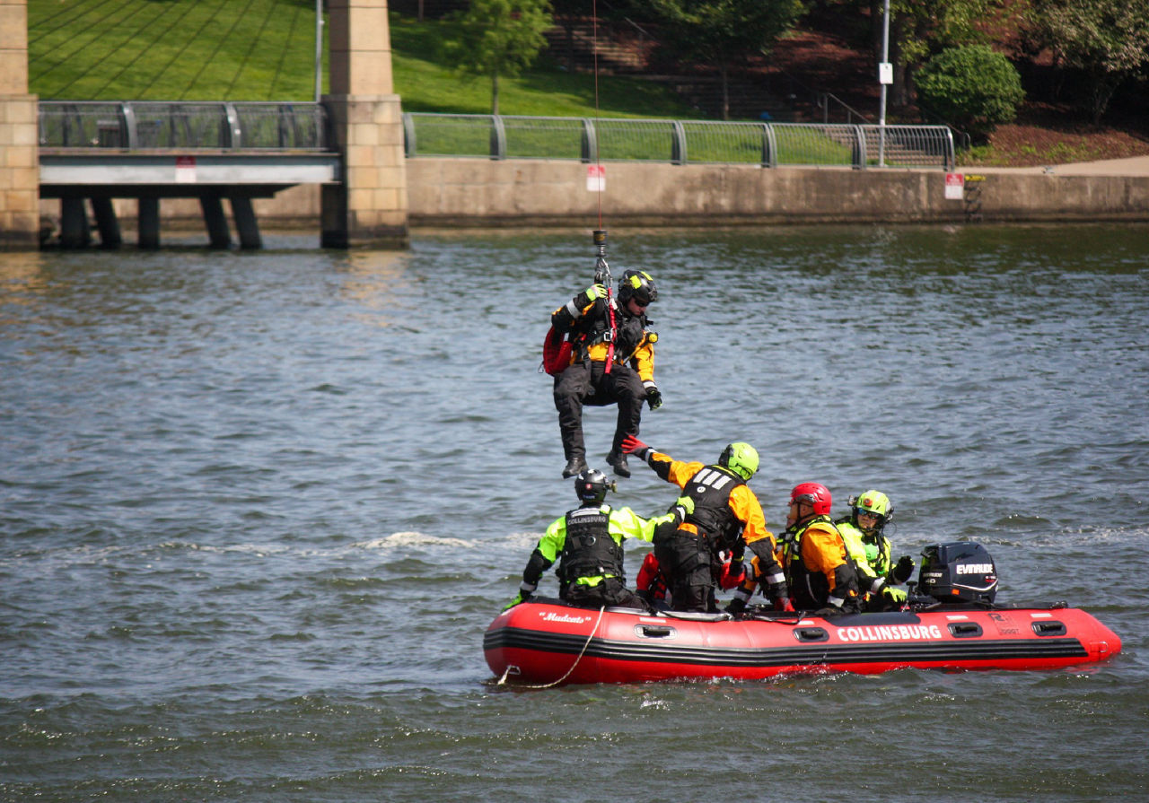 A swiftwater rescue team trains on a boat.