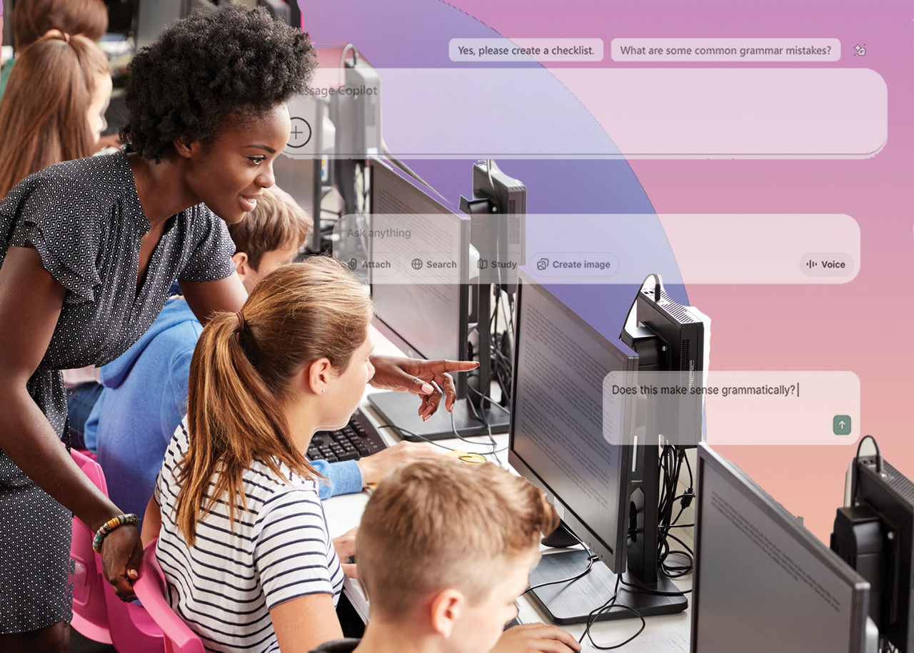 teacher showing student something on a computer