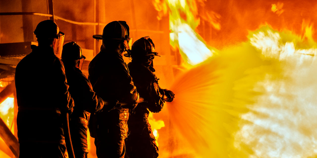Firefighters hose down a blaze.