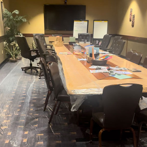 Wide view of activity tables including coloring Self-Care Tip Sheets, rock painting, pipe cleaners as fidgets, sensory stickers, a jar of care (mindfulness, self-care, and encouragement notes in a jar that participants could take while passing by), scent stickers, and printed brochures of mindfulness and grounding techniques.