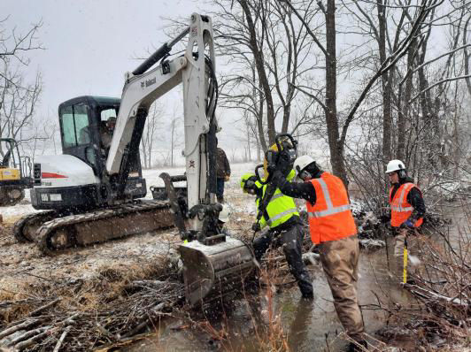 Photo of PFBC and partners excavating and restoring habitat in the Winter to a stream in the Turtle Creek Watershed, PA