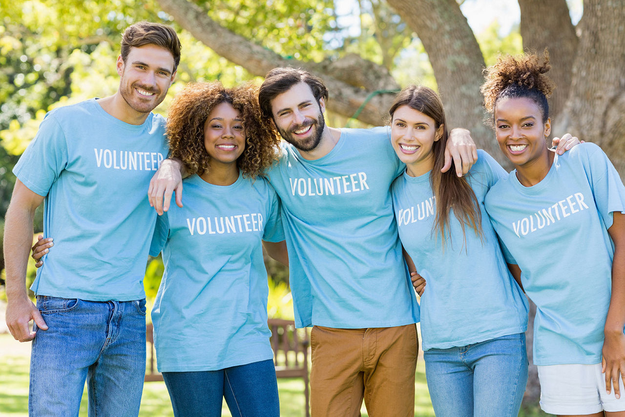 Five people wearing shirts that say "Volunteer"