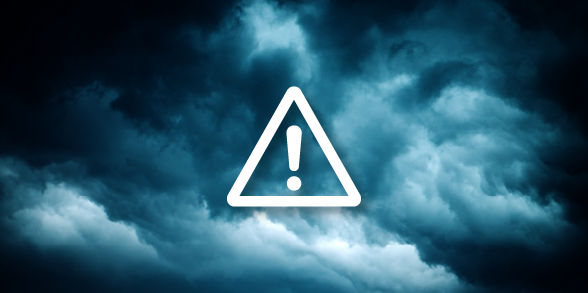 Alert icon over a stormy sky.