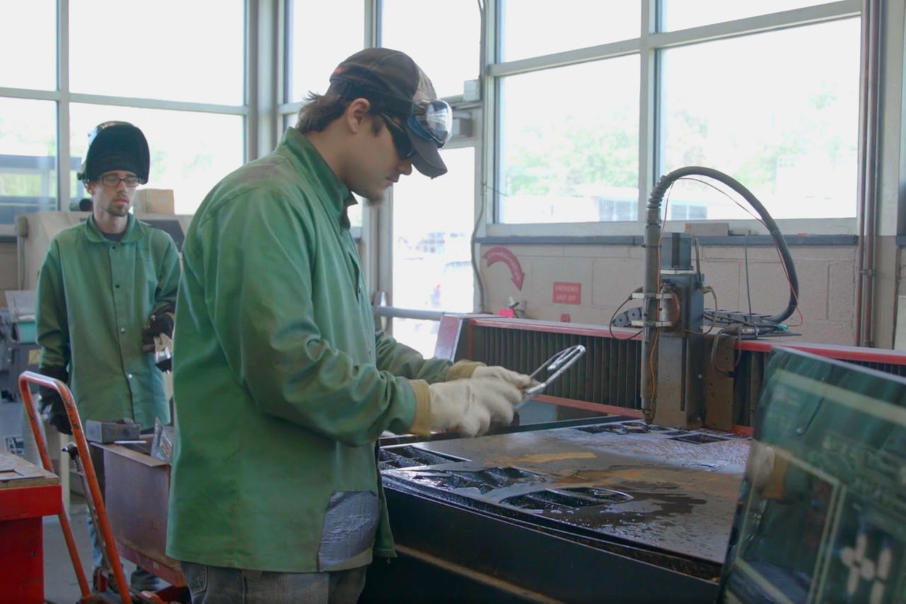 Welding student uses tools in class