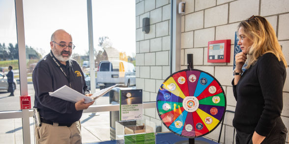 PEMA employees spin the "Wheel of Misfortune" to teach people about common emergencies in Pennsylvania.