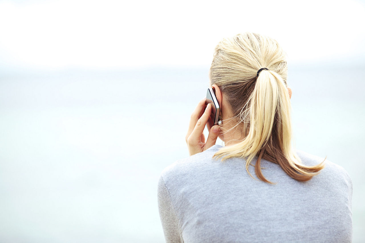 Rear view of woman chatting on a mobile