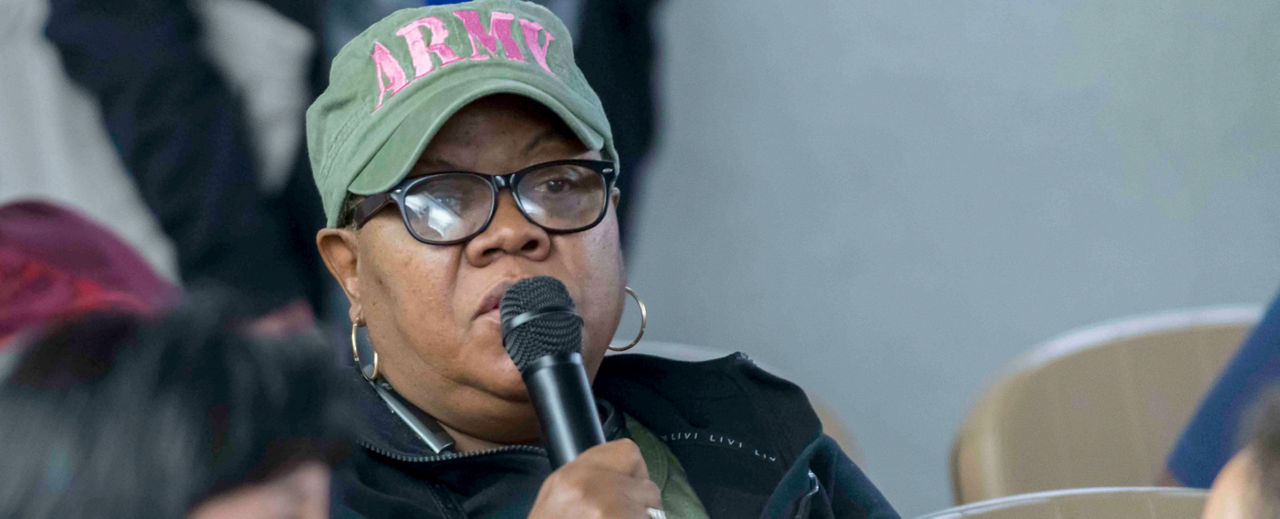 Female Veteran Speaking into a Microphone