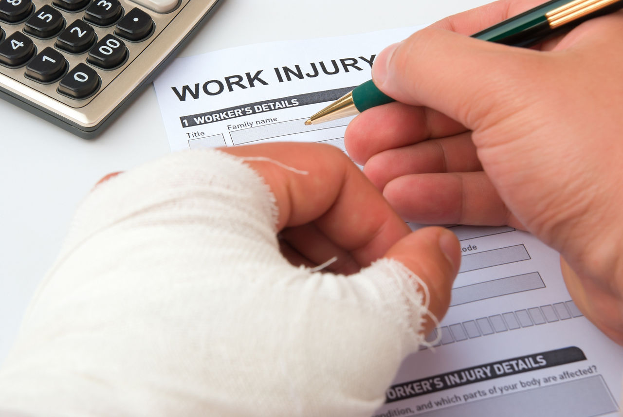 Person with cast on left hand fills out Work Injury Claim form.