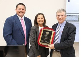 Labor & Industry Secretary stands with Zartman Construction, Inc. leadership holding a 2025 GASE plaque