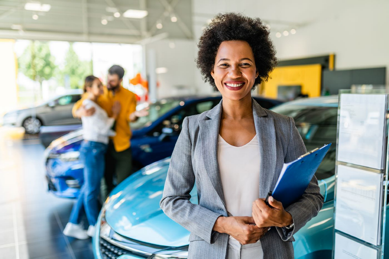 smiling finance officer helps car buyers find the chevy lease for them