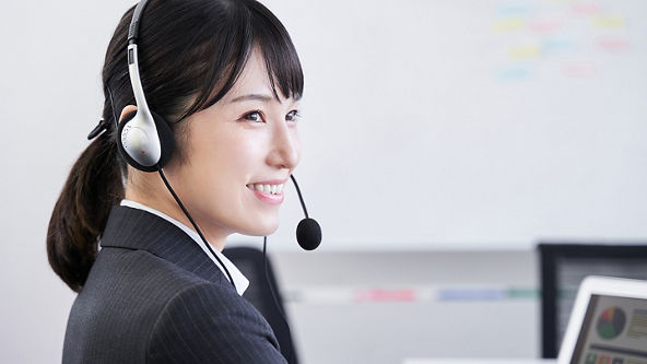 Female wearing a headset and looking off to the right