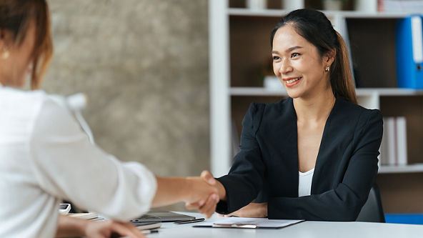 Two business woman shaking hands