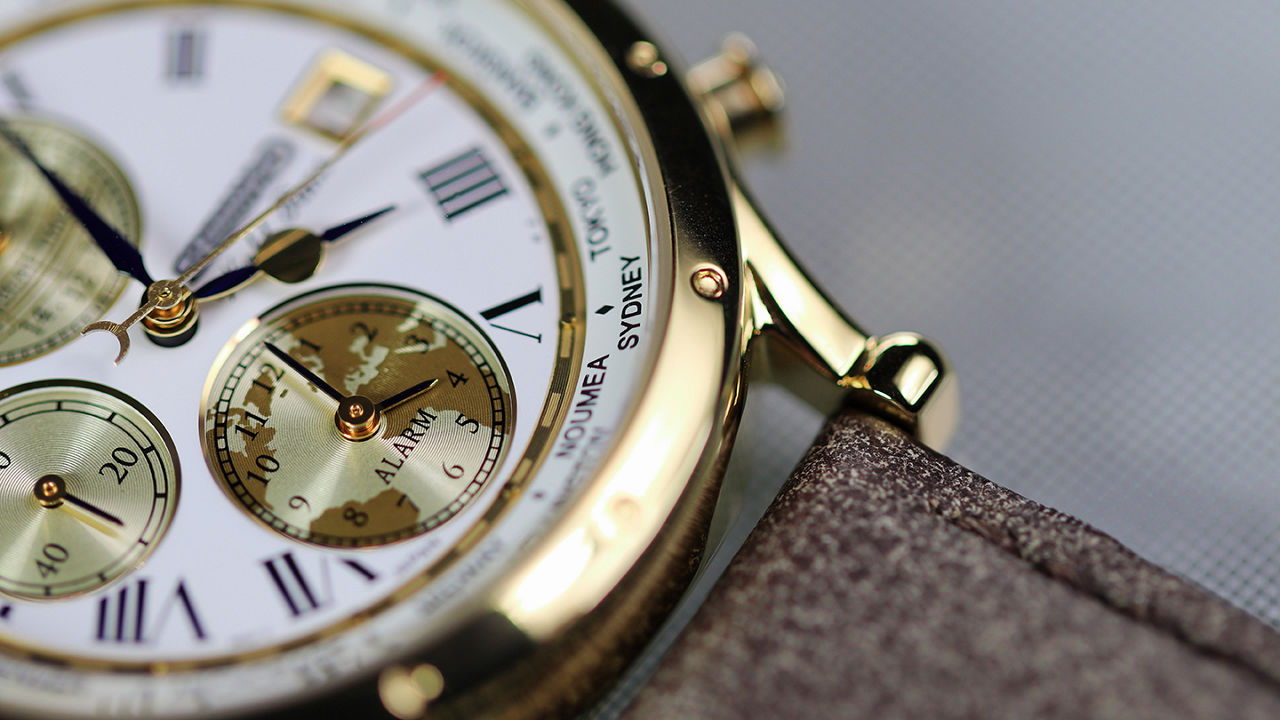 Close up of a gold and leather watch 