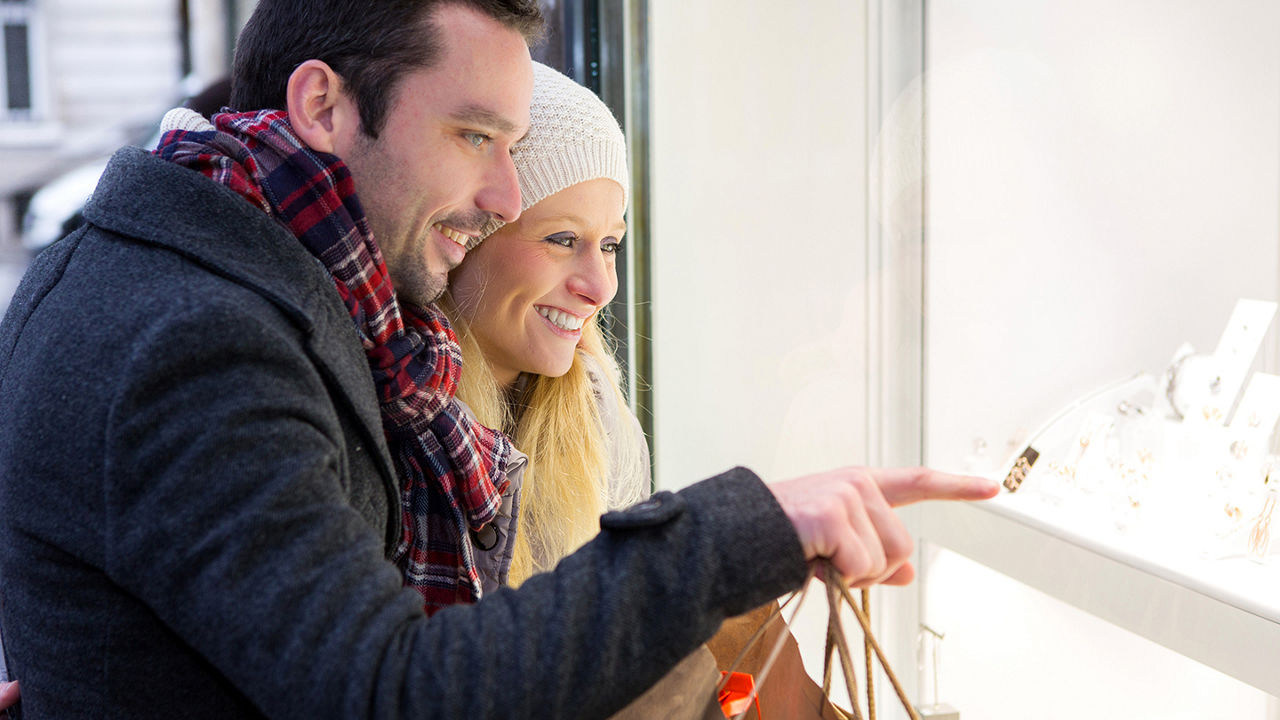 View of a young attractive couple doing some window shopping at a jewelry retailer