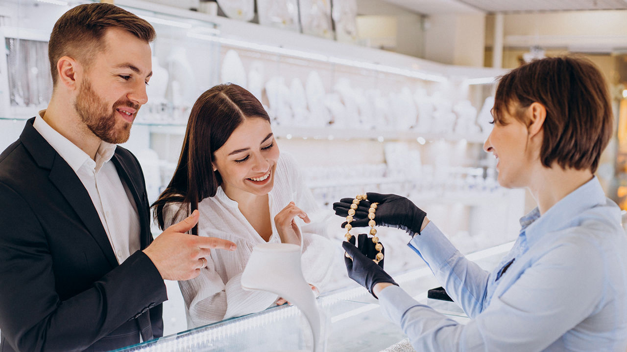 Couple at jewelry shop choosing a necklace together