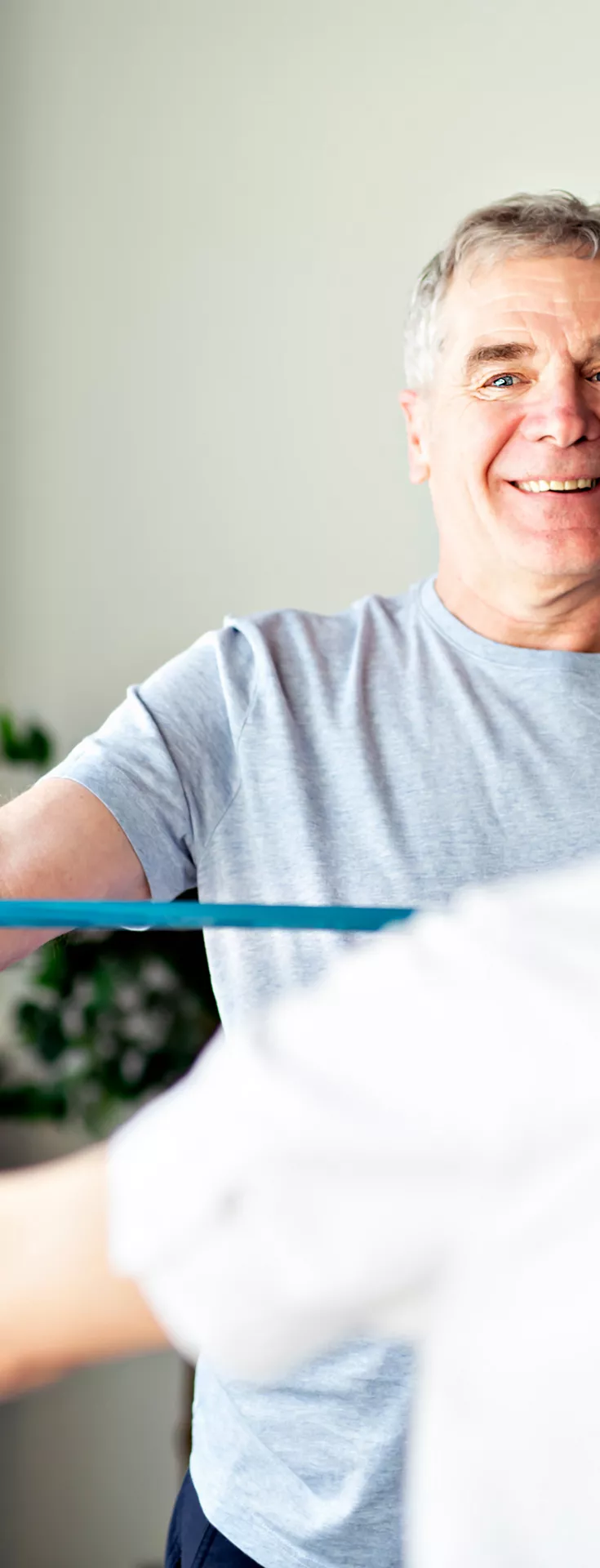 Modern rehabilitation physiotherapy worker with senior client