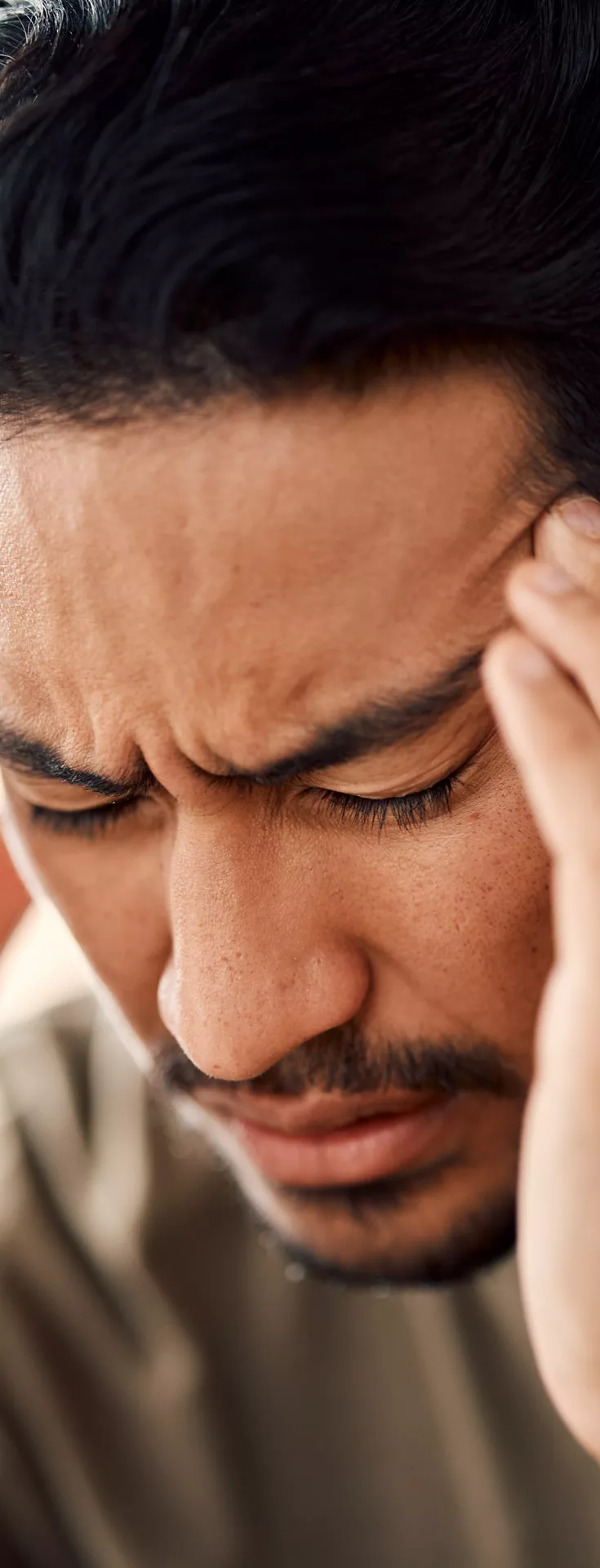 Man, headache and pain in home from stress, mental health fatigue and mind problem. Face, sick and depression of frustrated male person in anxiety, brain fog and dizzy from failure, worry and vertigo.
