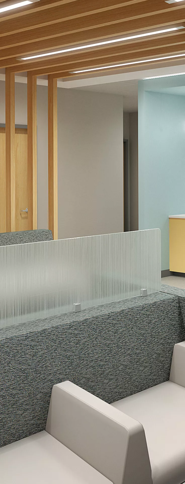 The image shows a contemporary waiting room in a healthcare facility, featuring a sleek reception desk and comfortable seating. The space is well-lit with overhead lights and has wood accents on the ceiling.