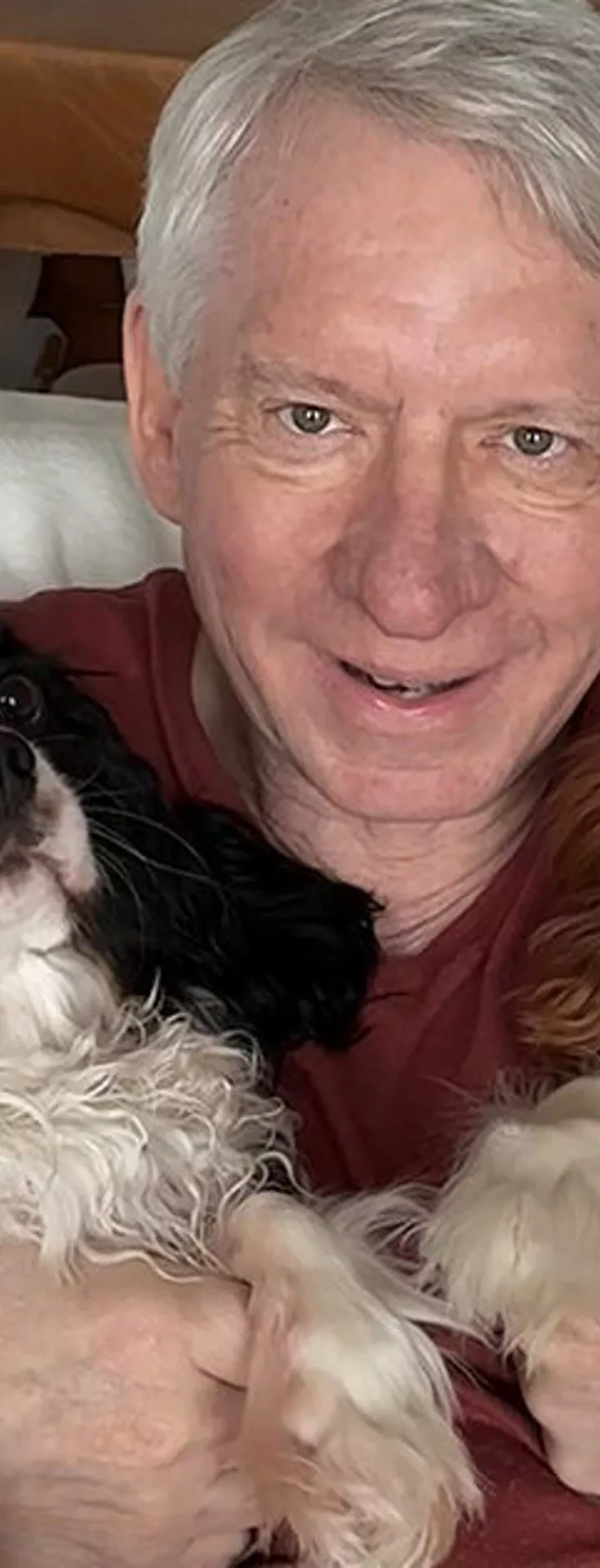 A man holding two dogs