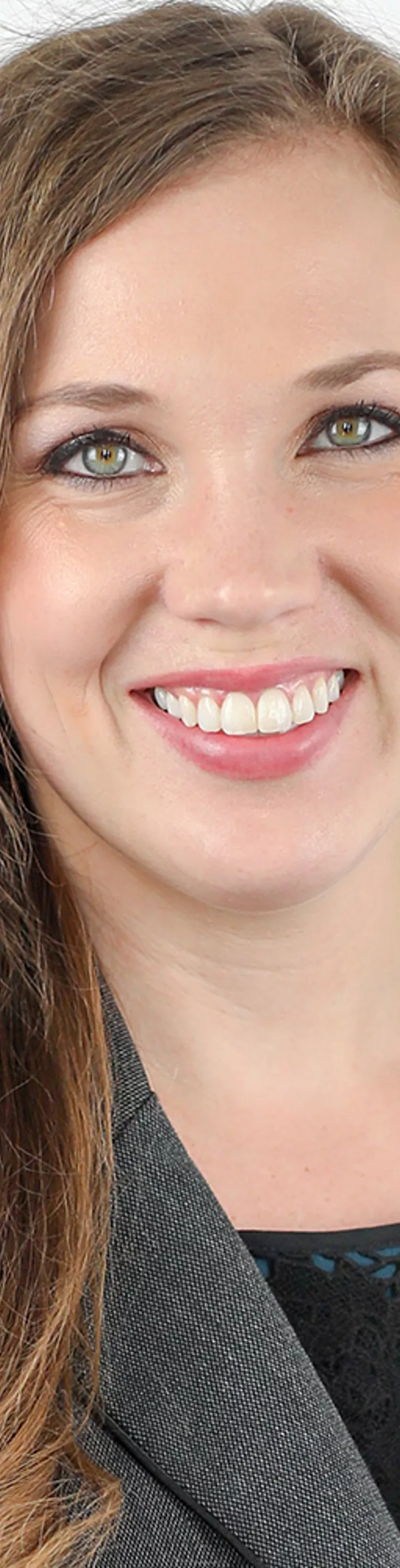 Headshot of Alyssa Aguirre.  She is wearing a grey blazer and a turquoise and black blouse.