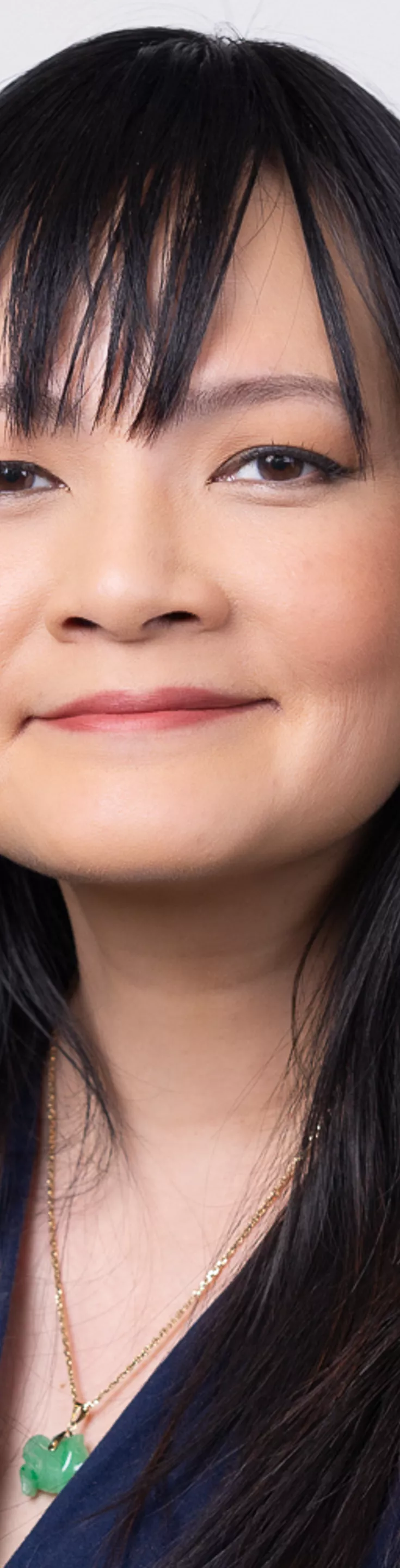 Headshot of Amy Tao Foster. She is wearing a blue blouse.