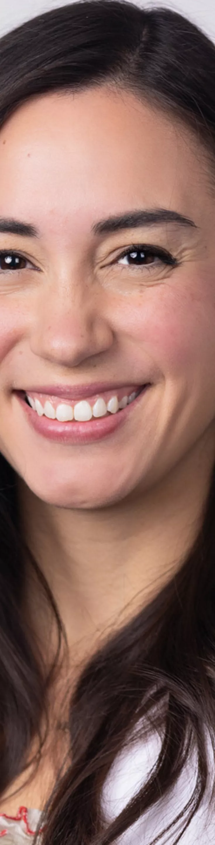 Headshot of Ashley Westrum. She is wearing a white blouse and a white coat.