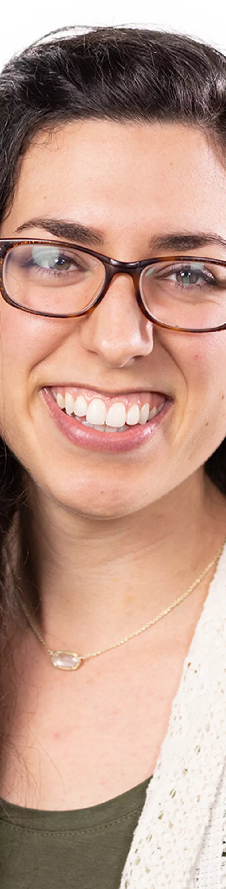Headshot of Carla Cos. She is wearing an olive green blouse and a beige cardigan.