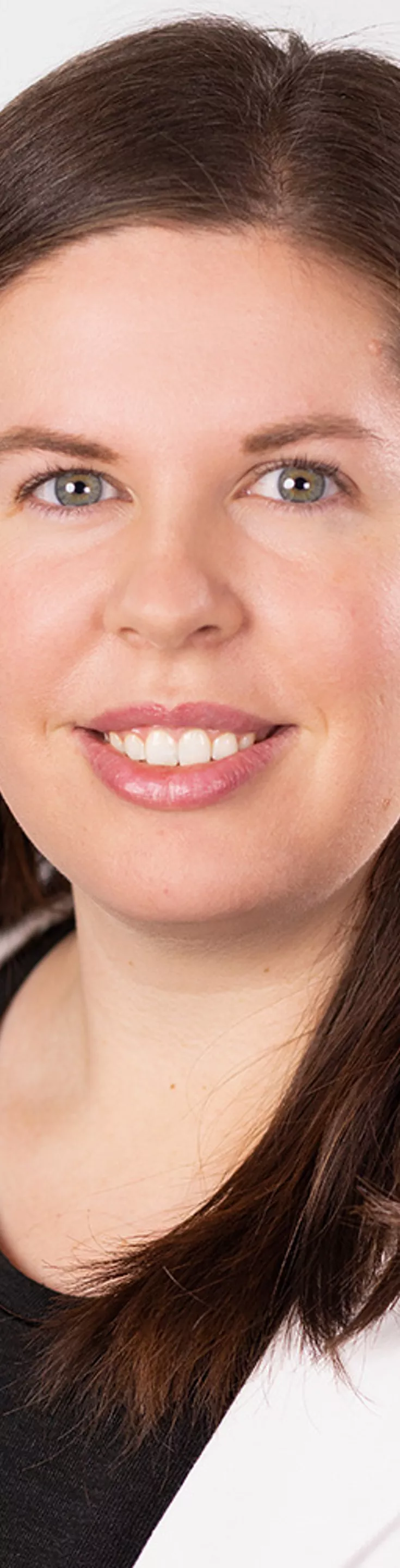 Headshot of Charley Peterson. She is wearing a black blouse and a white coat.