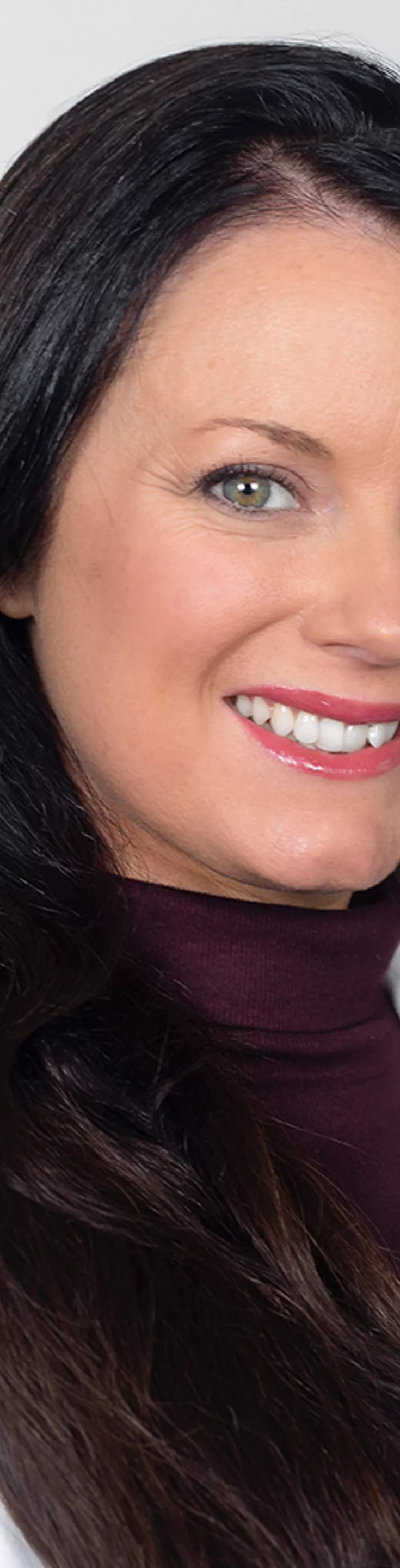 Headshot of Chelsey Sparks. She is wearing a maroon blouse and a white coat.
