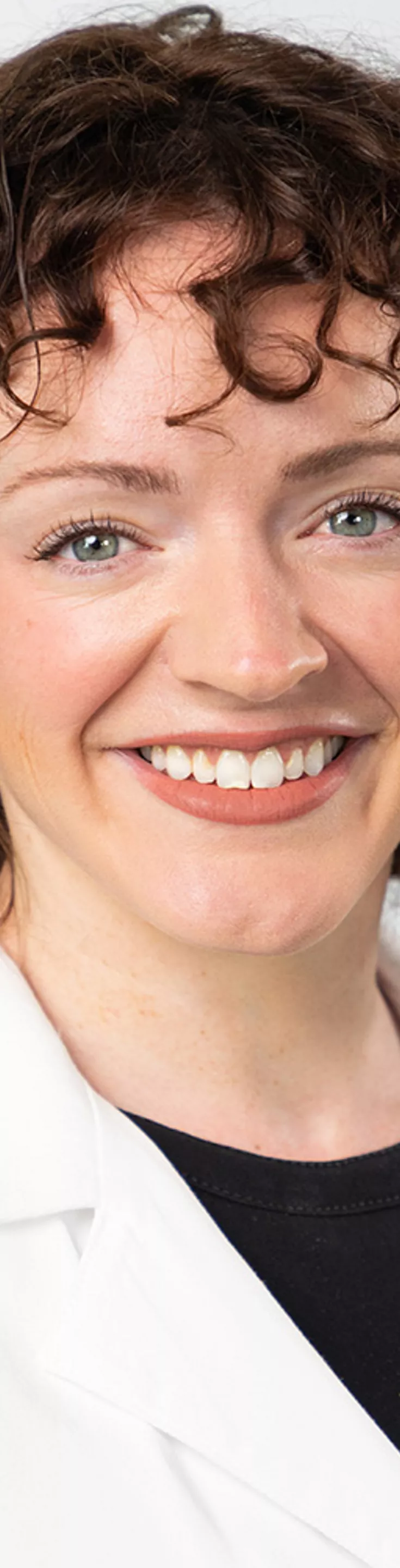 Headshot of Christine Bartow. She is wearing a black blouse and a white coat.