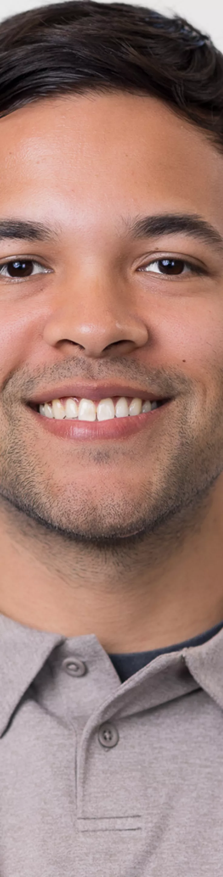 Headshot of Corey Henley. He is wearing a brown polo and a white coat.