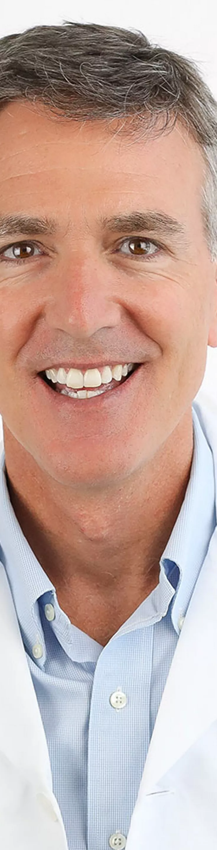 Headshot of David Ring.  He is wearing a white coat and a light blue dress shirt.