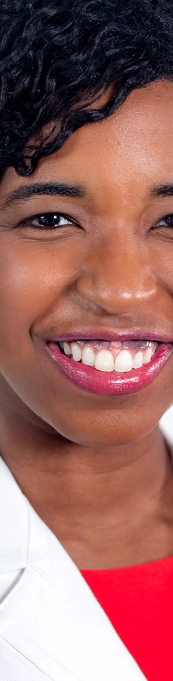Headshot of Denise Johnson. She is wearing a red blouse and a white coat.