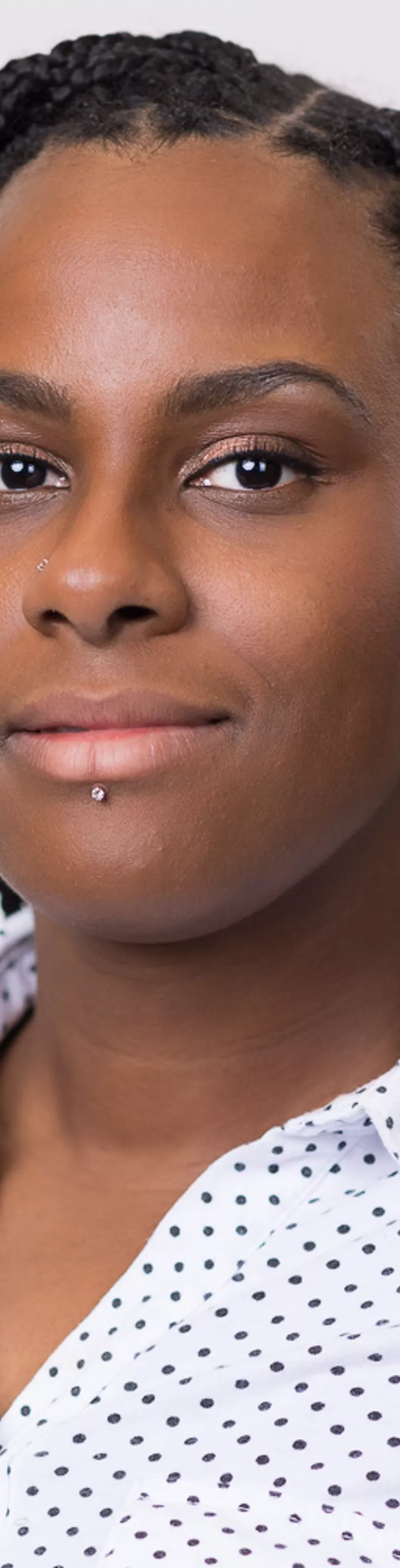 Headshot of Deon Davis. She is wearing a white polka dot blouse.