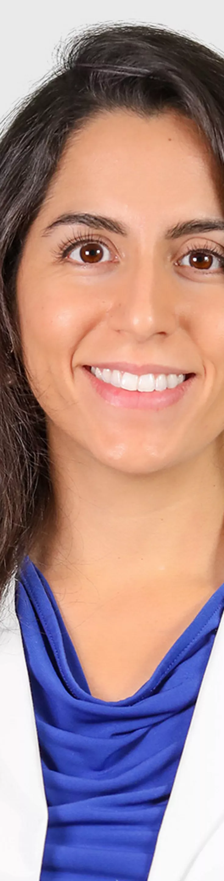 Headshot of Diana Mendoza. She is wearing a blue blouse and a white coat.