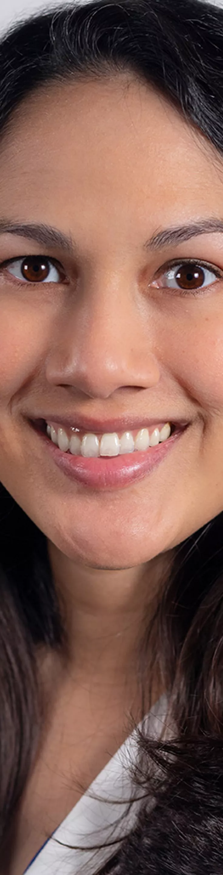 Heasdhot of Eileen Bowden. She is wearing a blue blouse and a white coat.