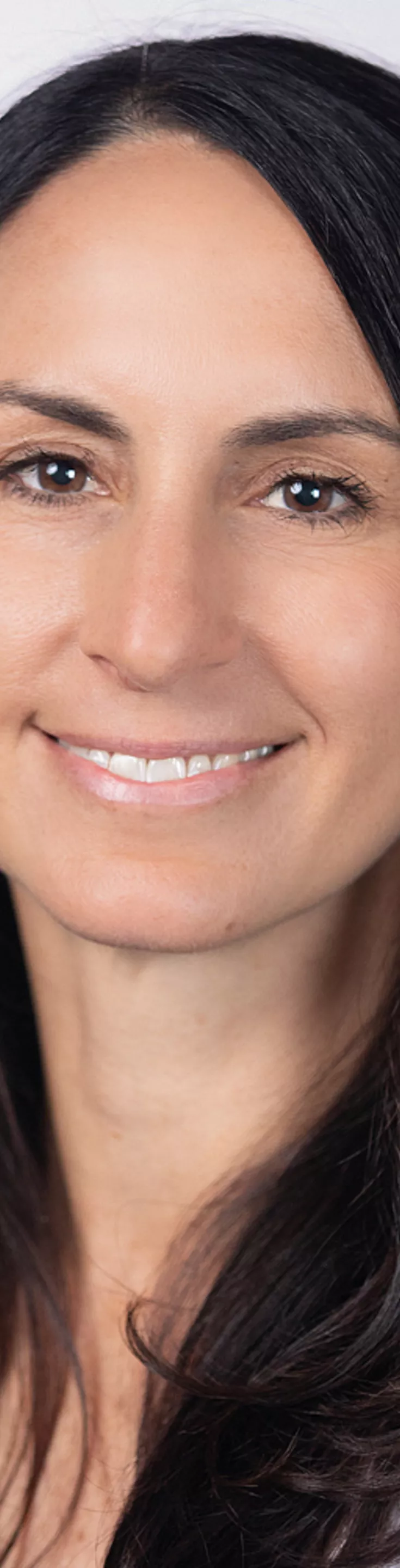 Headshot of Elizabeth Whitten. She is wearing a blue blouse and a white coat.