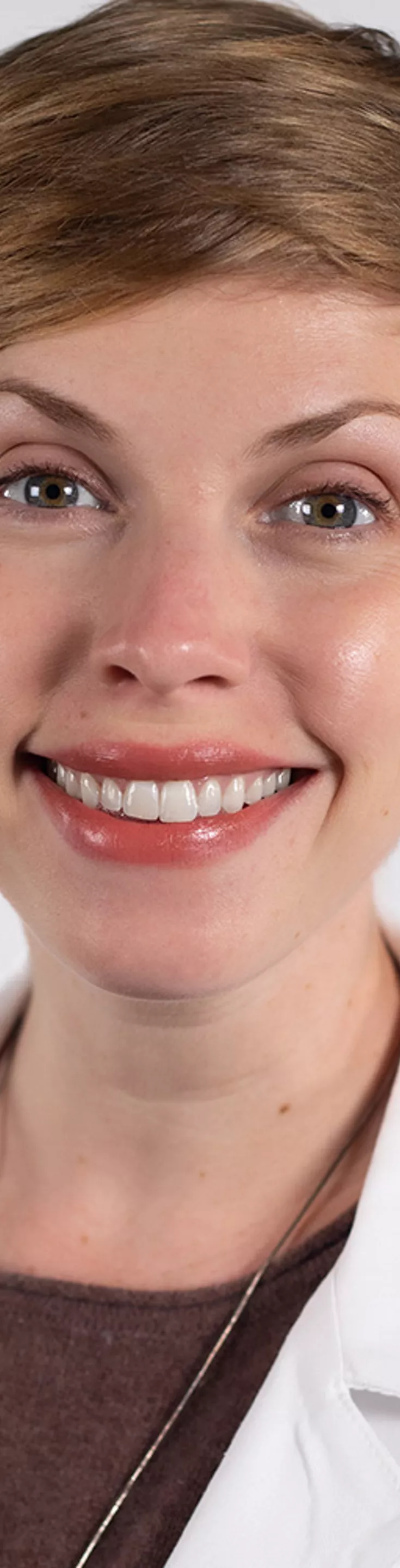 Headshot of Erin Richardson. She is wearing a brown sweater and a white coat.