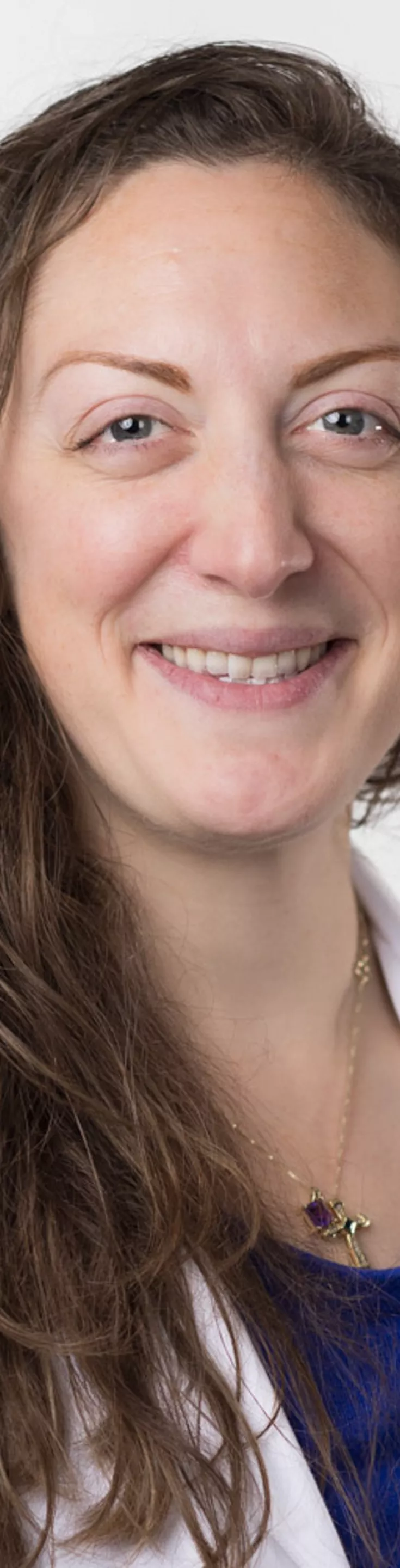 Headshot of Irene Nelson. She is wearing a blue blouse and a white coat.