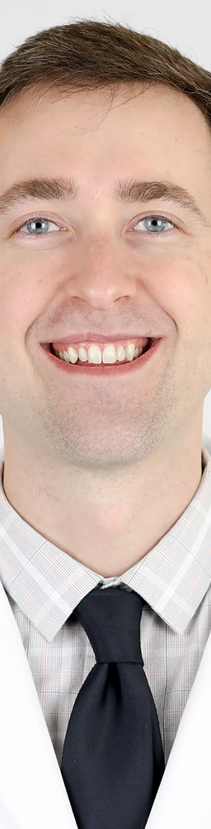Headshot of Jeffrey Saniuk.  He is wearing a white coat and a navy tie.
