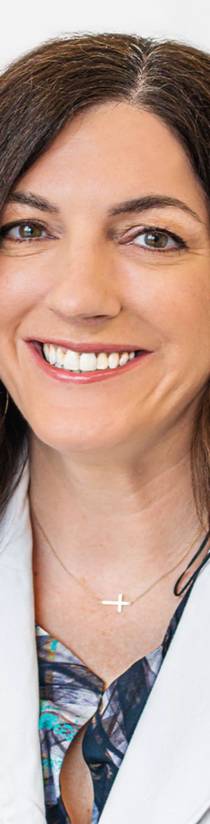 Headshot of Kimberly Brown. She is wearing a blue blouse and a white coat.