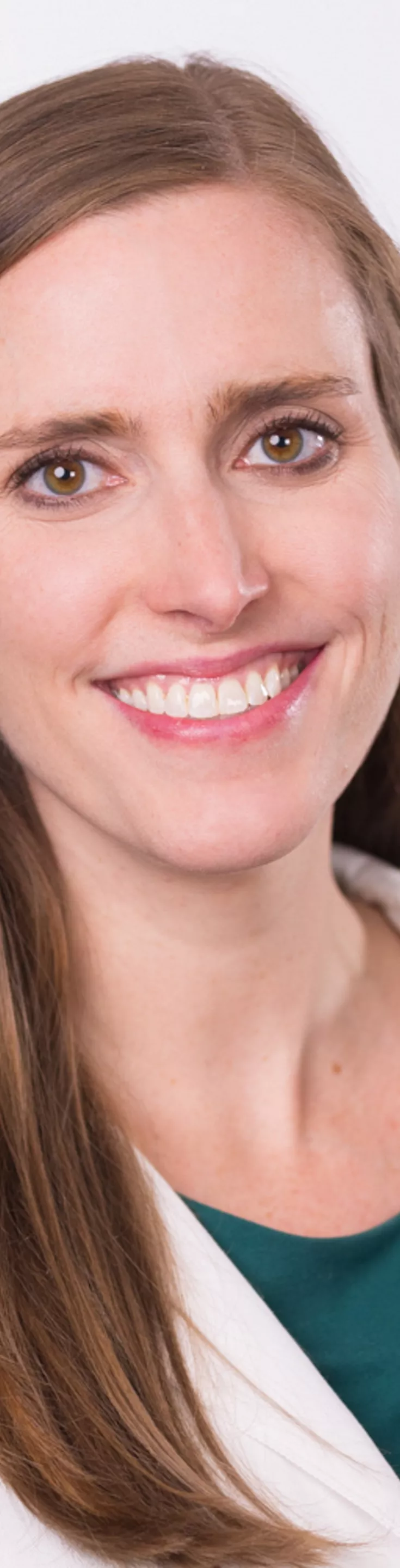 Headshot of Lauren Caldwell. She is wearing a teal blouse and a white coat.