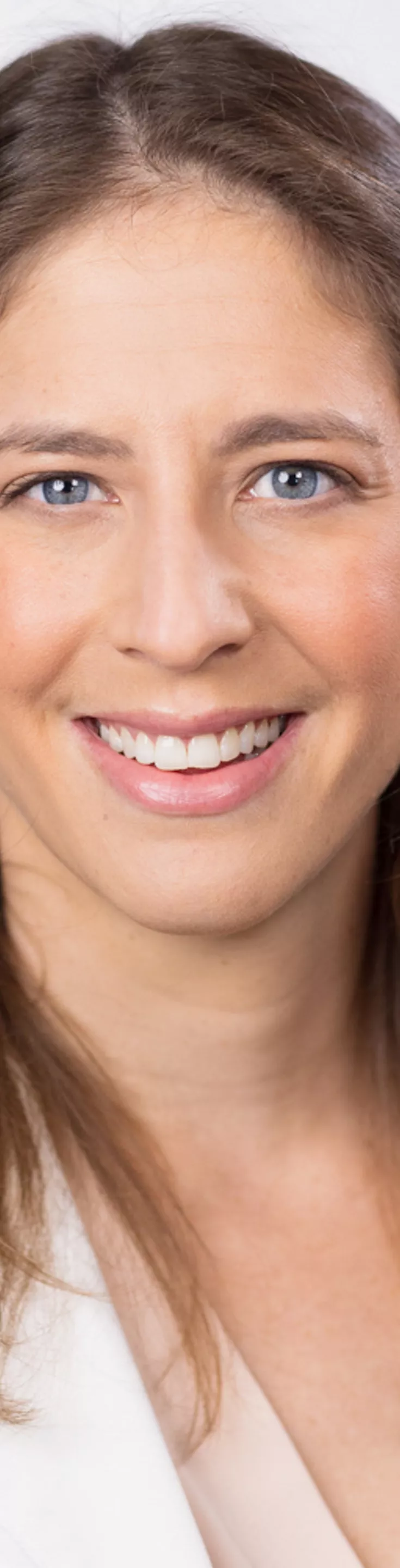 Headshot of Lisa Boyars. She is wearing a beige blouse and a white coat.