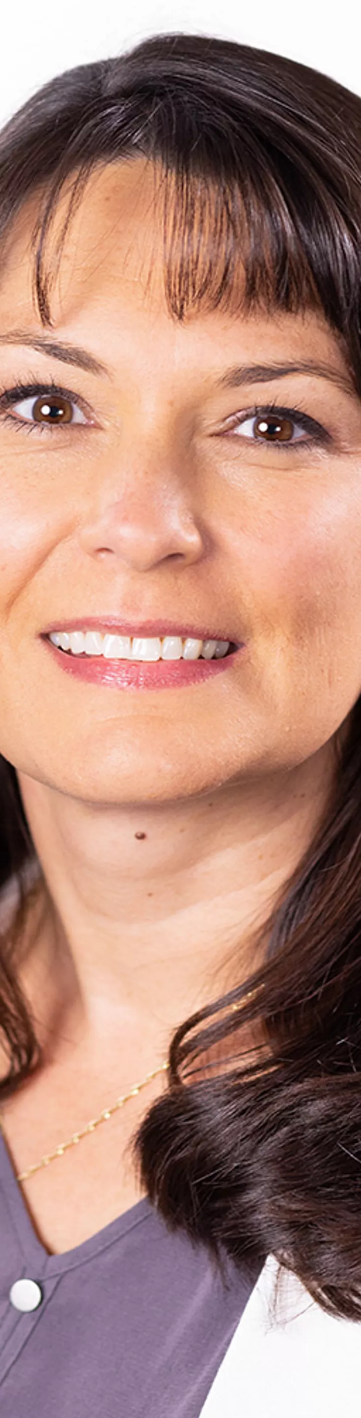 Headshot of Lisa Hadorn. She is wearing a purple blouse and a white coat.