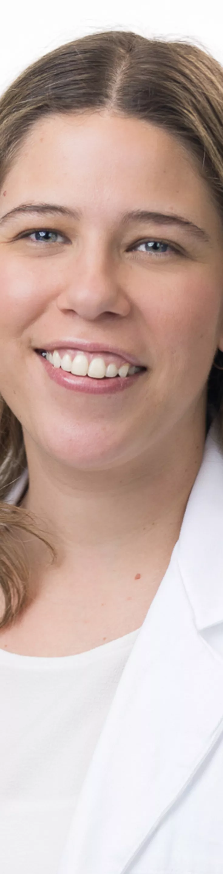 Headshot of Patrizia Perazzo. She is wearing a white blouse and a white coat.
