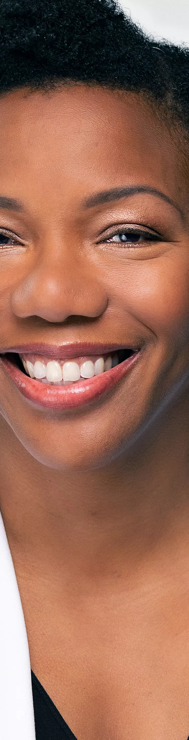 Headshot of Yvette Willaims. She is wearing a black blouse and a white coat.