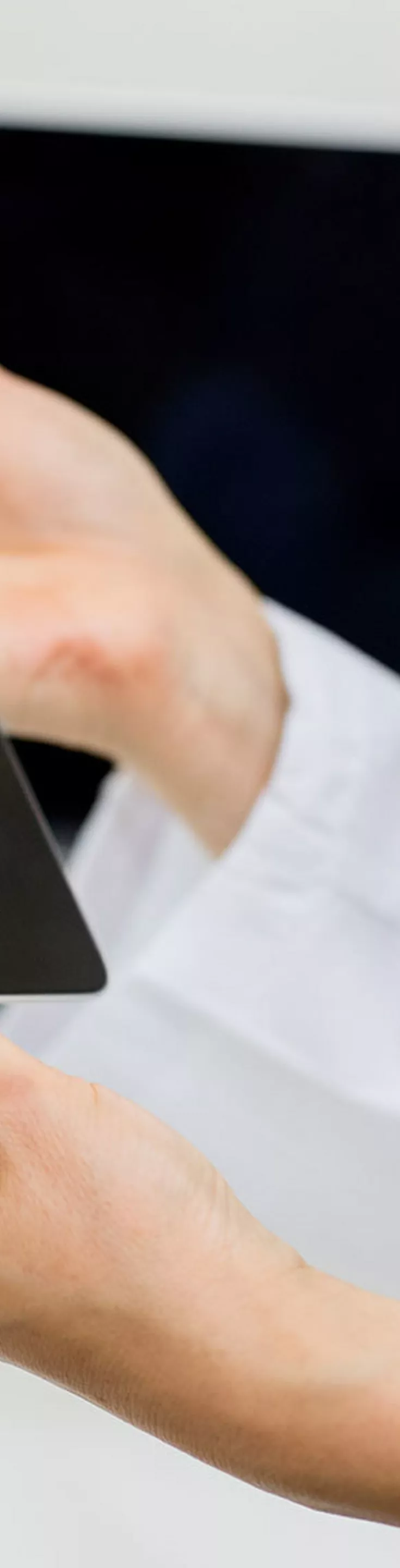 Two medical professionals examine a digital tablet displaying multiple brain scan images. The setting appears to be a clinical or hospital environment, with a focus on diagnostic activity. 