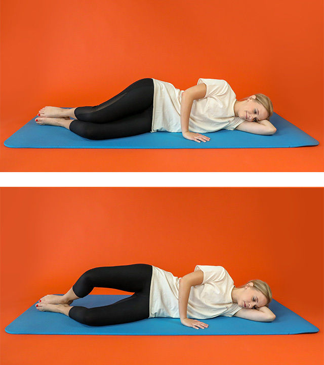 A young woman is shown performing a side-lying leg exercise on a blue mat against a solid orange background. She is dressed in a white t-shirt and black leggings, lying on her side with her head resting on her arm. The two images illustrate the start and end positions of the exercise, focusing on controlled leg movement. The setting is minimal and brightly colored, emphasizing the fitness activity.