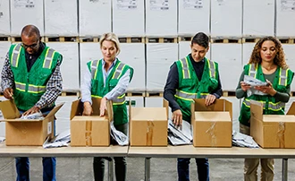 Automated packaging machinery with an open cardboard box on a conveyor belt.